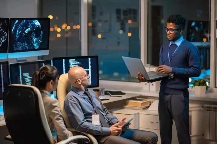 Young successful businessman with laptop doing a presentation.